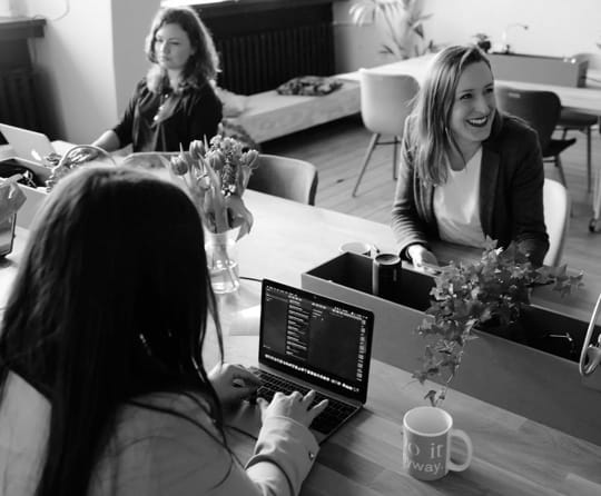 colleagues sitting at an office desk